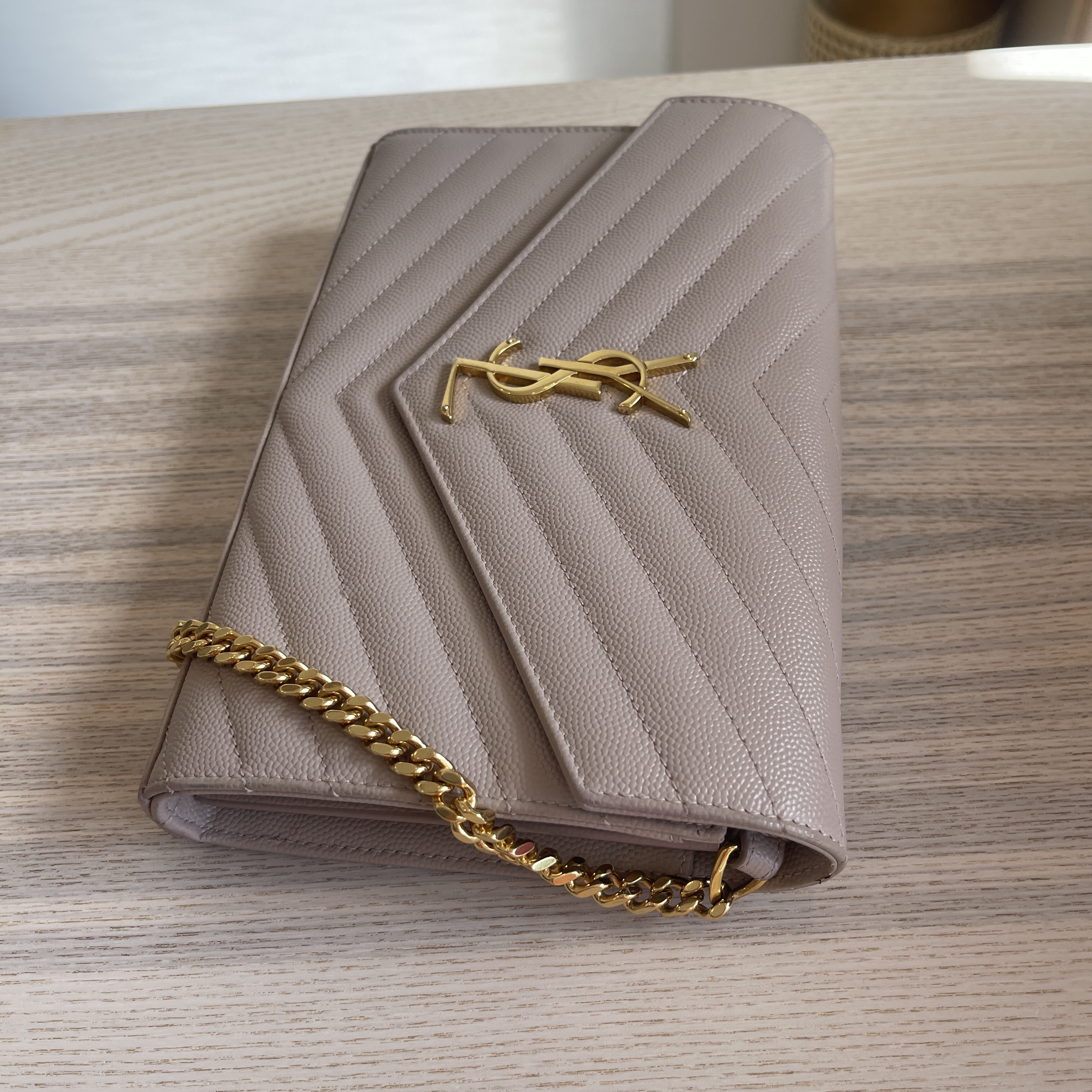 — YSL's envelope chain wallet gives casual