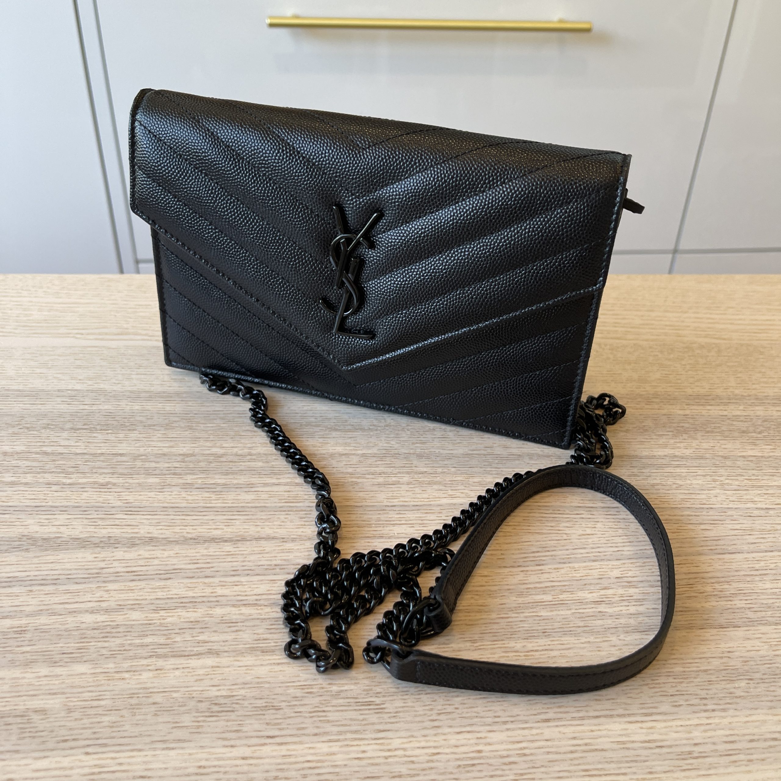 — YSL's envelope chain wallet gives casual